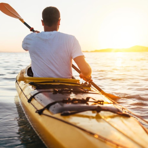 a man in a yellow kayak