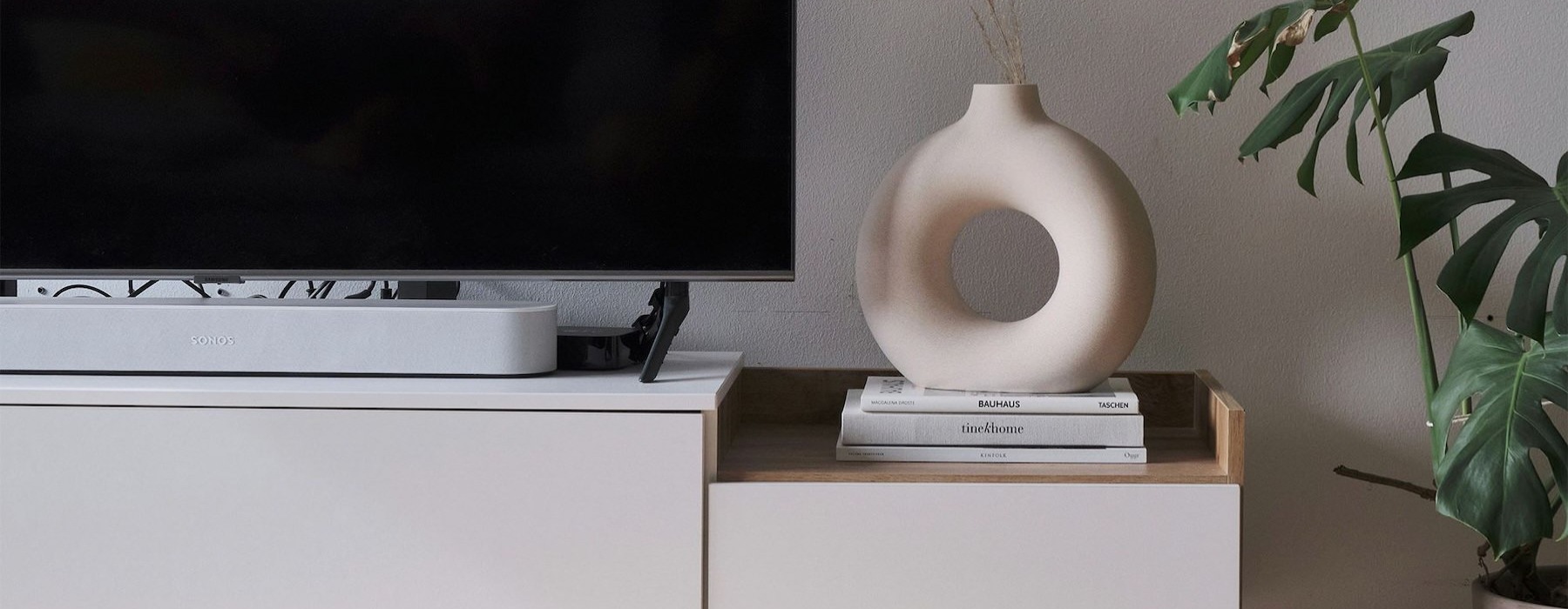 a tv on a stand with decor