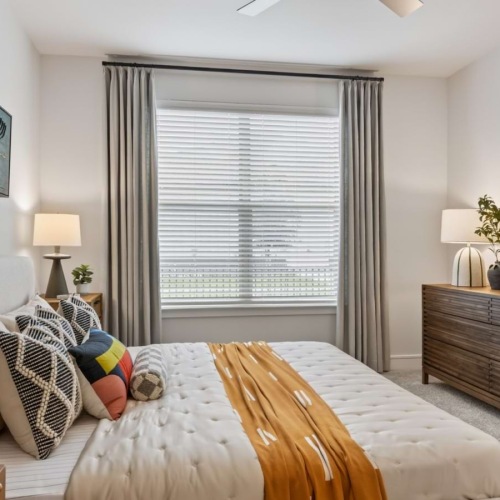bedroom with bed, window and nightstand